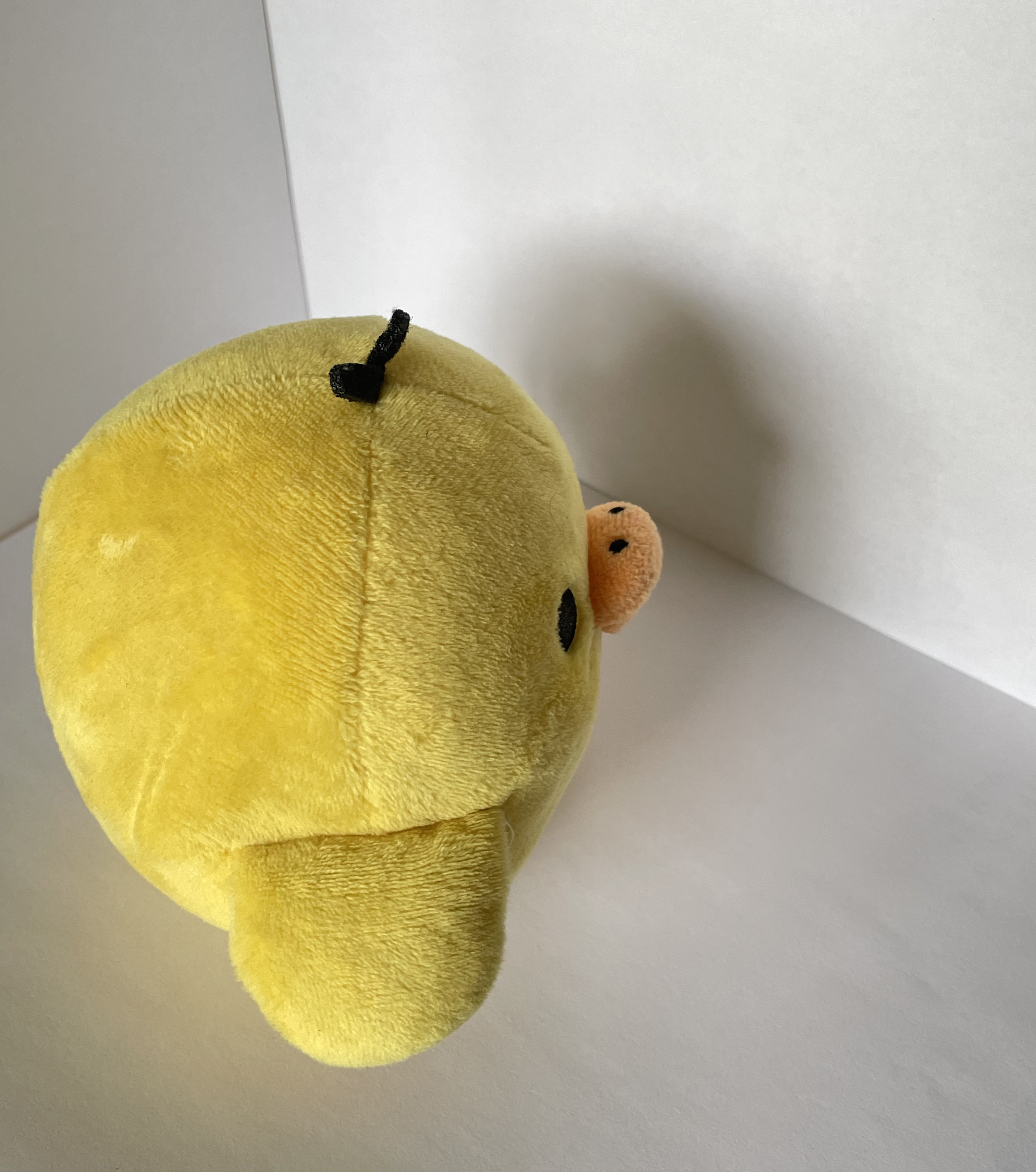 The side view of the chicken plushie.