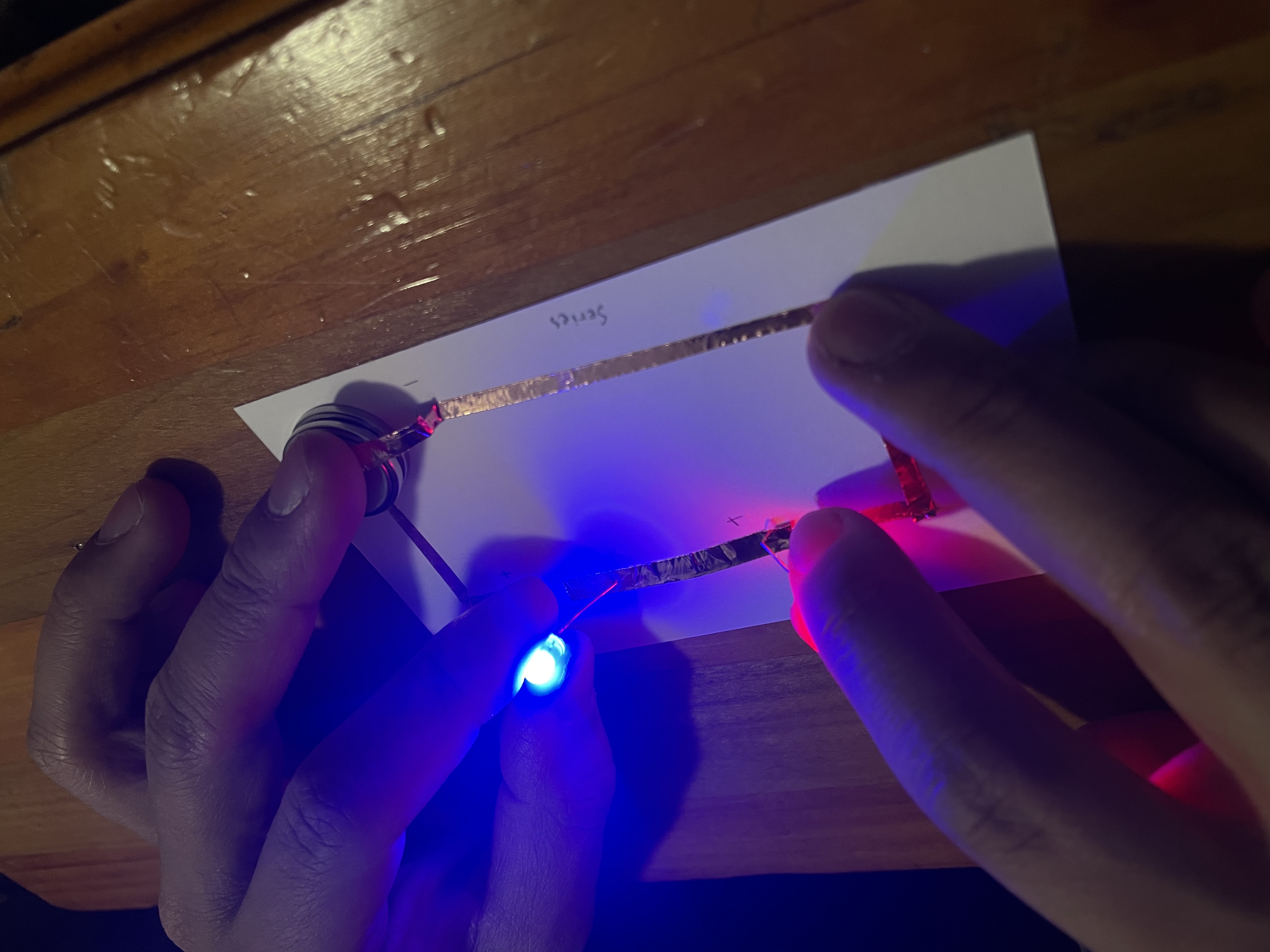As I tried troubleshooting my circuit, I asked my brother to help me and give me two extra hands. We tried the same series circuit with the LED lights (with legs) again and it worked!