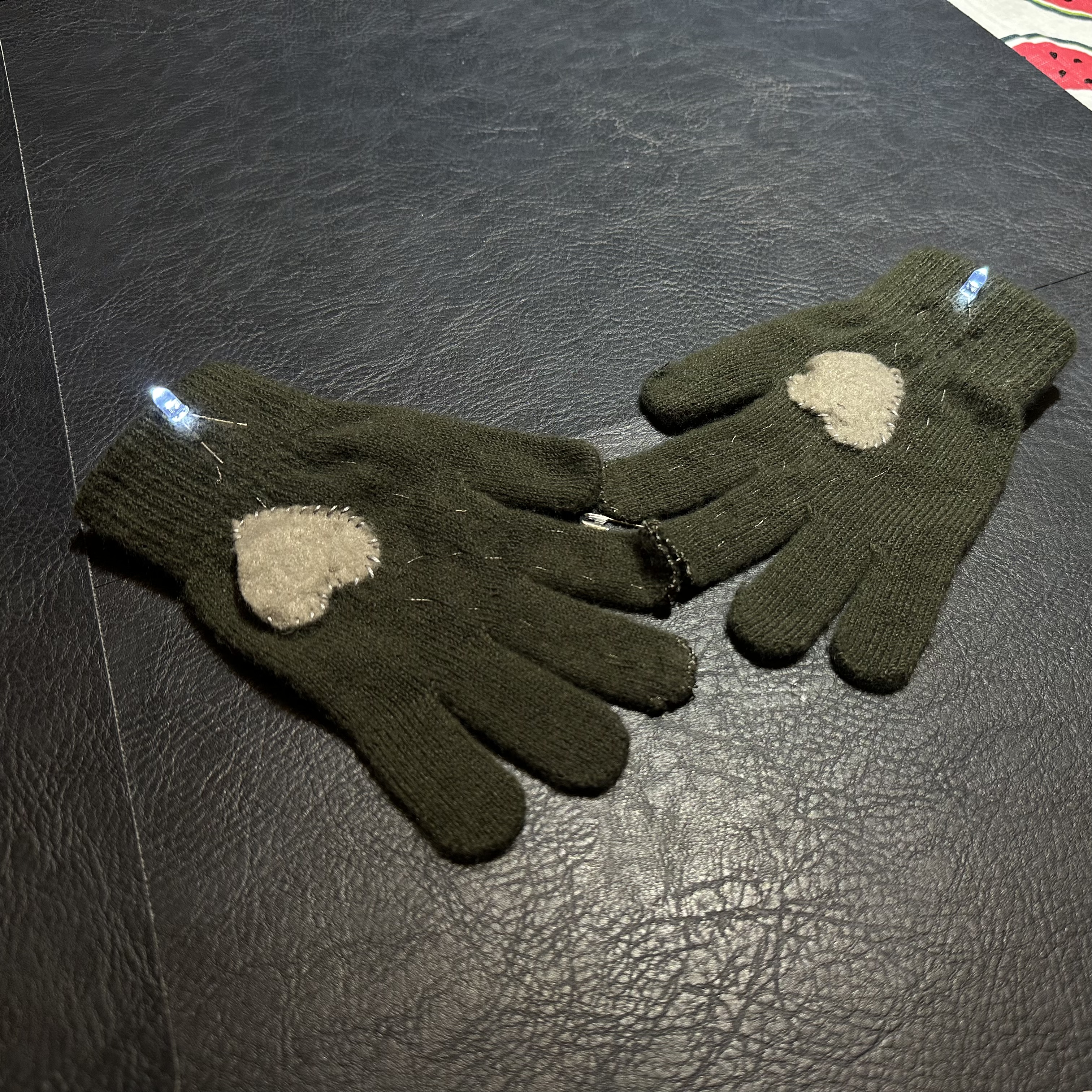 Once the the tips of the gloves connect, the lights at the writs light up to visually represent the connection.